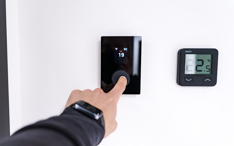 Modern smart thermostat controlling home HVAC system